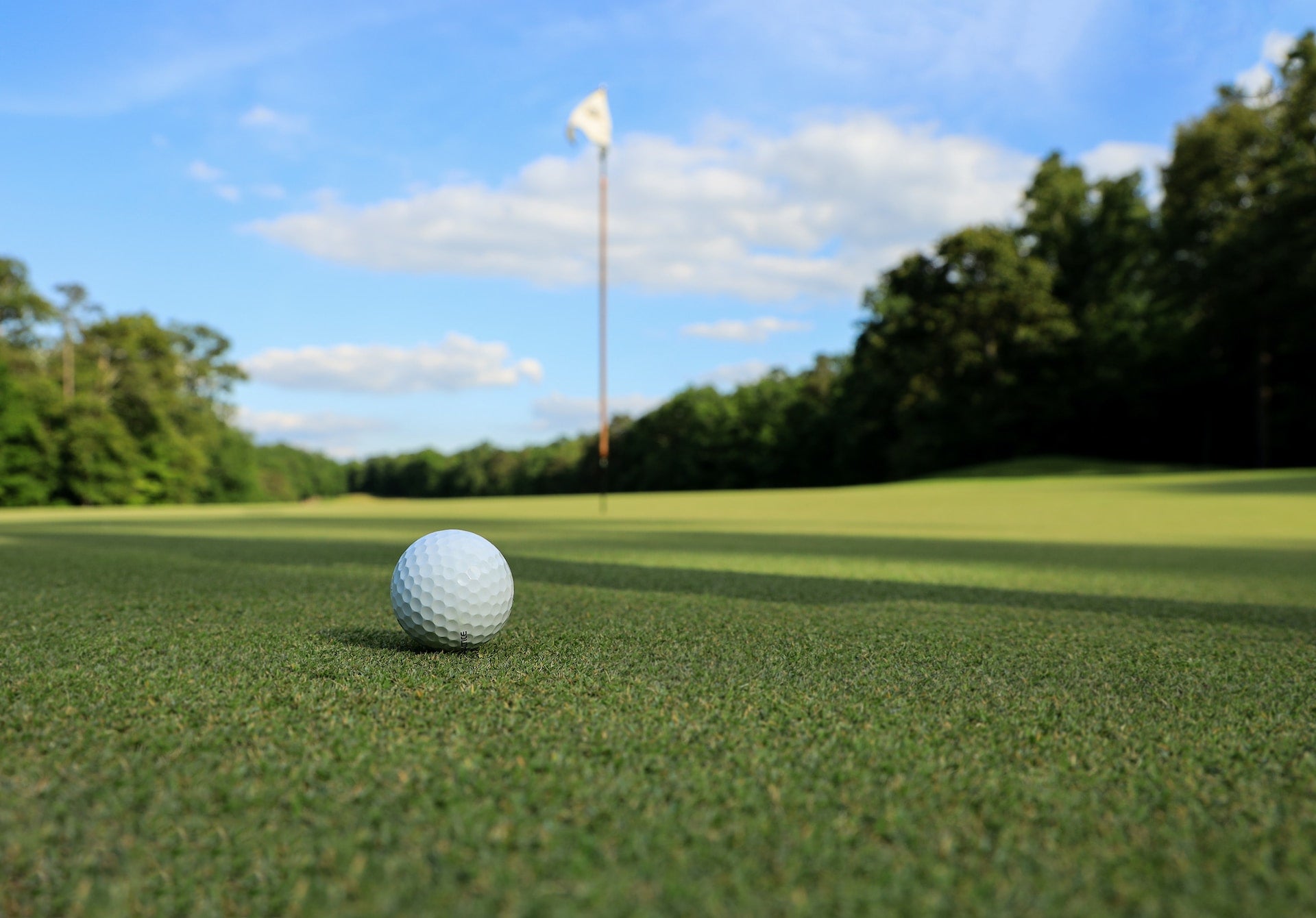 Golfing On The Putting Green On A Golf Course In The Tri-Town City Of Temiskaming Shores Where The Fairway Stretches Out By Lake Timiskaming & Pine Trees That Provide A Beautiful Backdrop For Golfers In Haileybury & New Liskeard Ontario