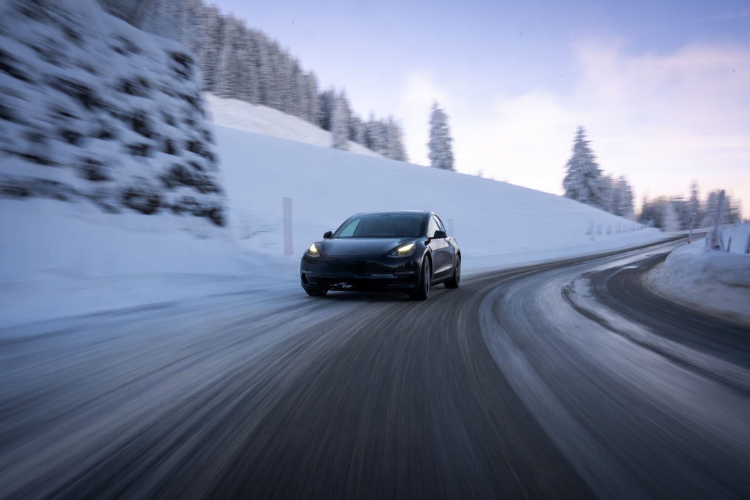 A Tesla Car Driving In Northern Ontario Winter Snow & A Mining & Refining Facility In The City Of Temiskaming Shores Cobalt For Battery Materials Sector Where A Sustainable Future Providing Economic Opportunities & Contributing To Greener Energy Systems